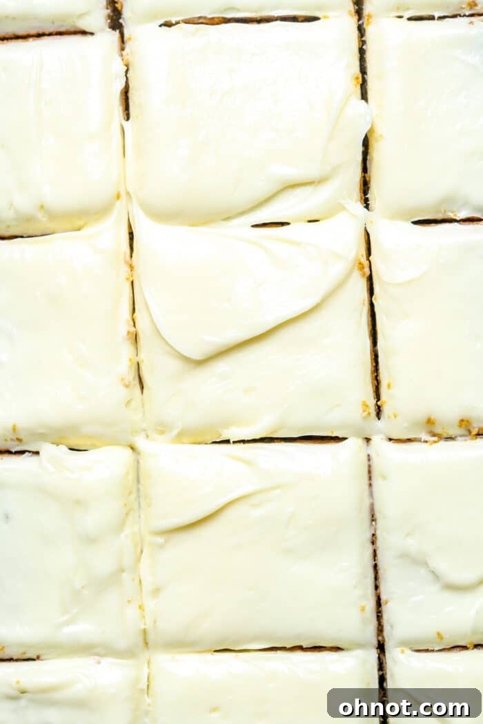 Delicious gluten-free pumpkin cake squares topped with cream cheese frosting.