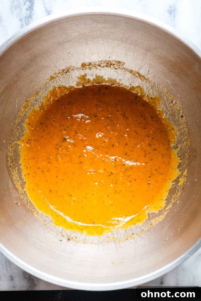 Pumpkin cookie batter in bowl.