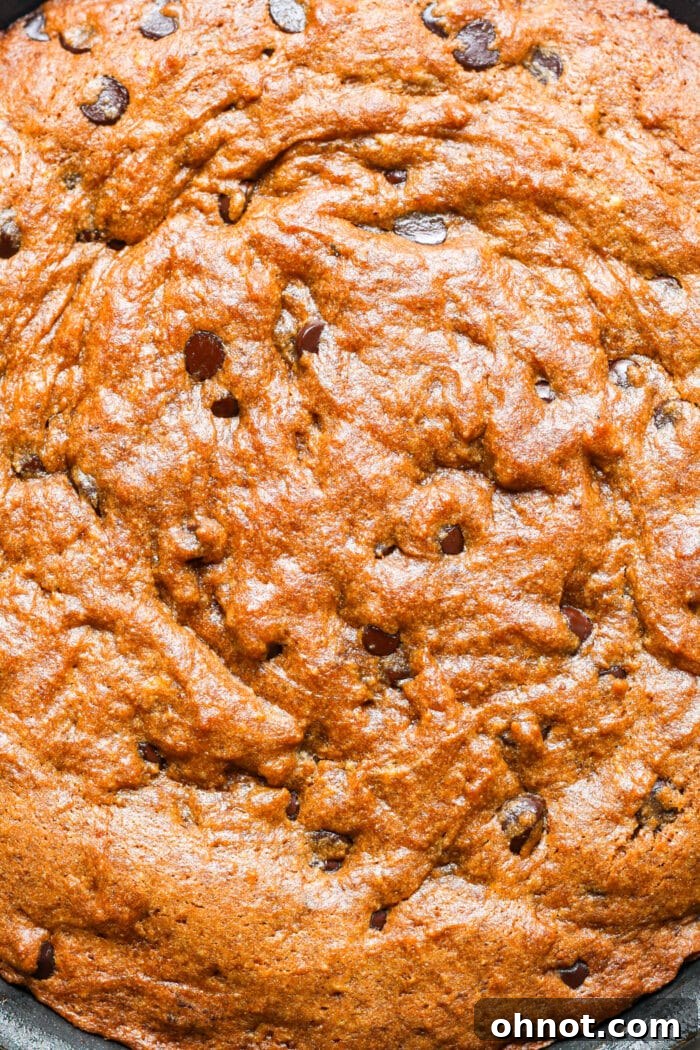 Close-up of the gooey center of a pumpkin skillet cookie.