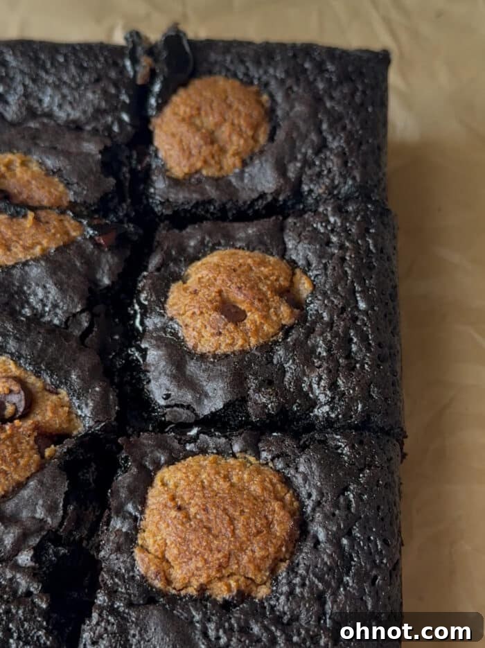 Close-up of cut chocolate chip brookie bars, showing the distinct layers.
