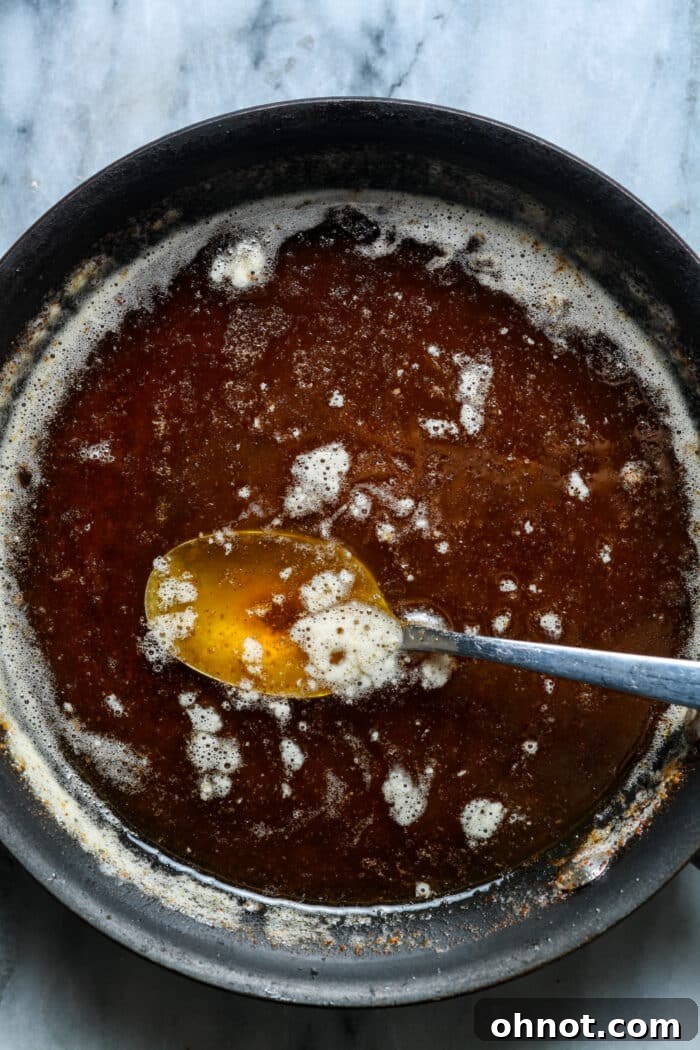 Butter browning in a skillet, displaying golden color and brown flecks.