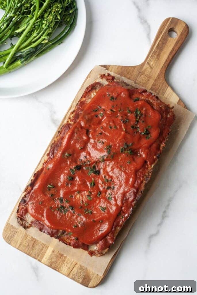 Loaf of Whole30 meatloaf with sauce on top