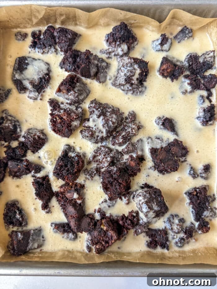 Unbaked chocolate bread pudding custard in a baking pan, ready for the oven.