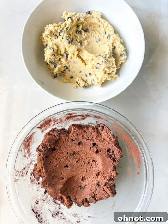 Unmixed chocolate and vanilla cookie dough in separate bowls, ready to be combined.