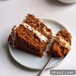 Paleo Hummingbird Cake on a white plate with pineapple in the background.