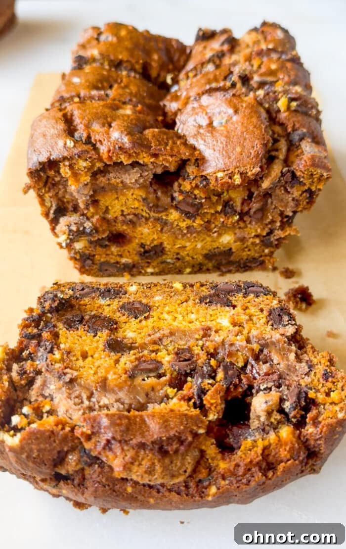 Thick, moist pumpkin bread loaf cooling on a wire rack.