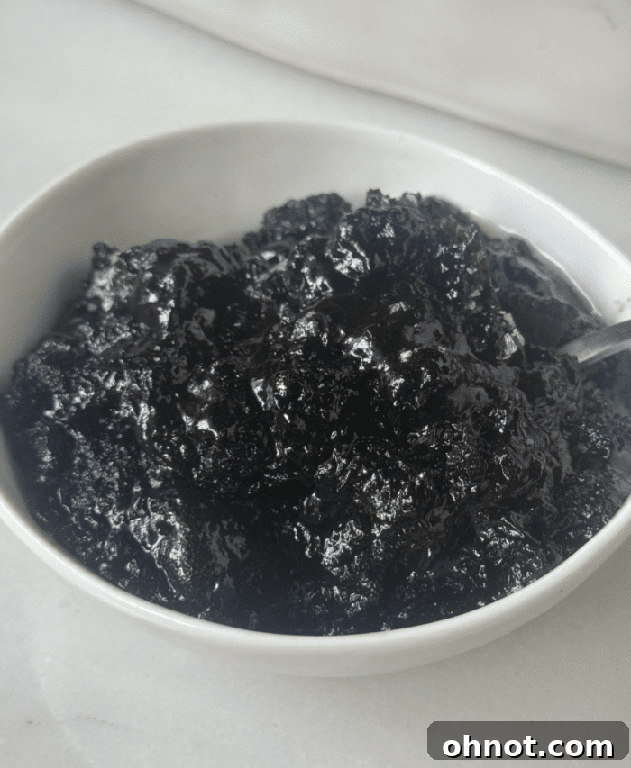 Close-up of brownie pudding in a bowl, showing its rich, dark brown color and smooth texture.