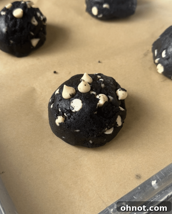 Inside out cookie dough scoops on a baking sheet.