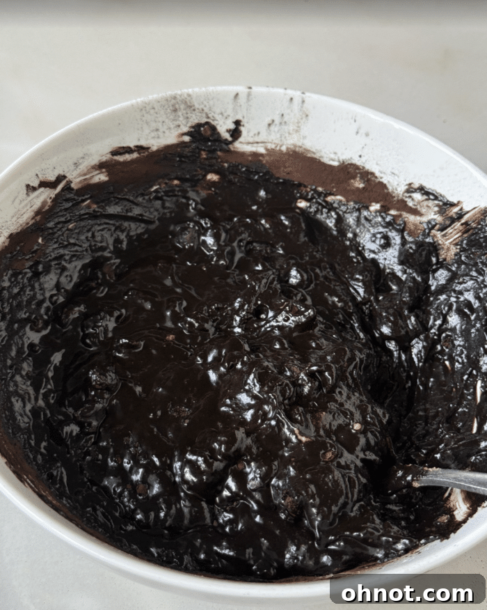 Chocolate protein cookie dough in a mixing bowl before baking