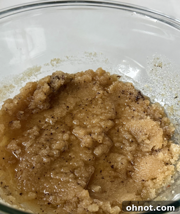 Creamy buttery dough in a large glass mixing bowl