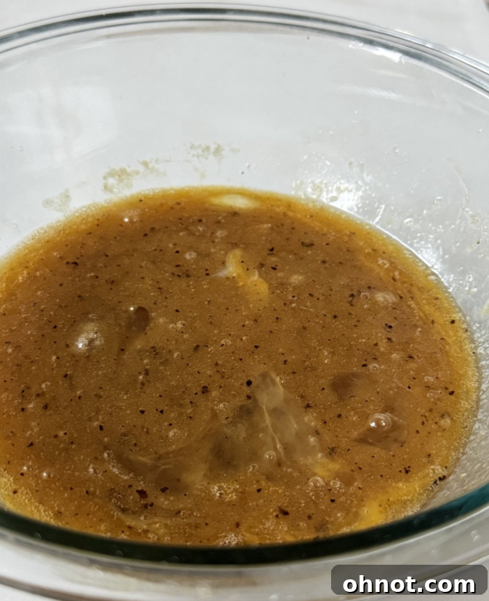 Golden brown butter cooling in a mixing bowl