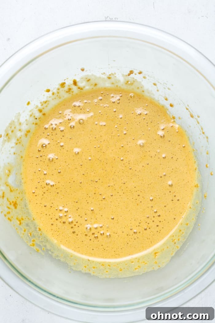 Egg and coconut sugar beaten until light and frothy in a glass bowl.
