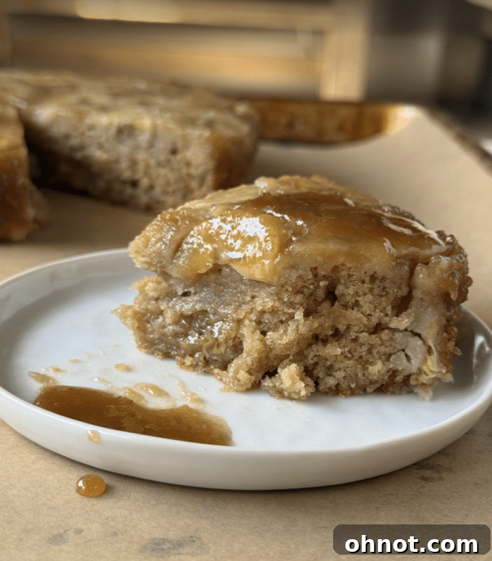 A close-up shot of a gooey, delicious bite of banana upside down cake.