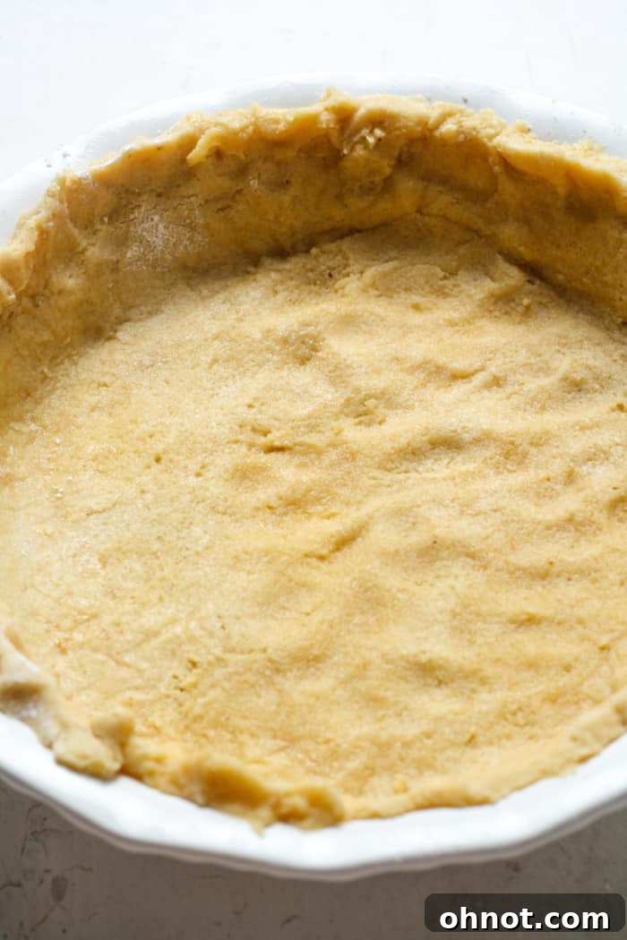 A plain baked Paleo pie crust, perfectly golden and waiting for a delicious filling.