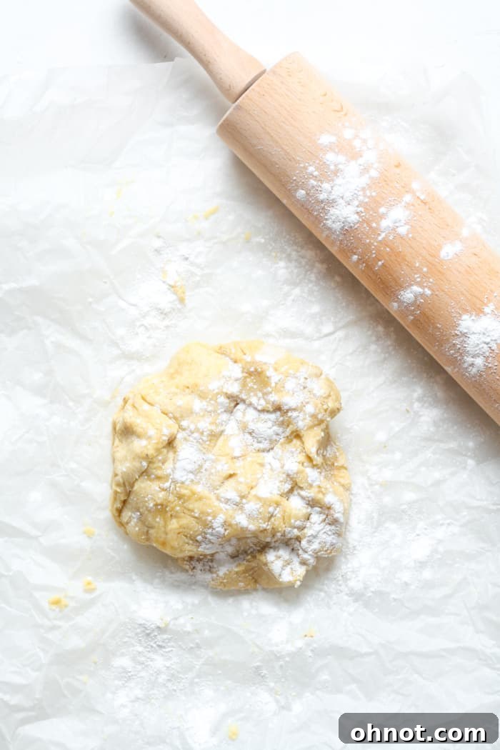 Chilled pie dough, a rolling pin, and parchment paper generously dusted with tapioca flour.