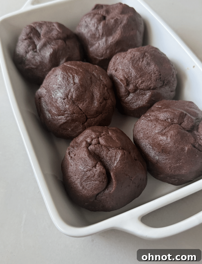 Freshly baked brownie scoops still in the baking pan, golden and fudgy.