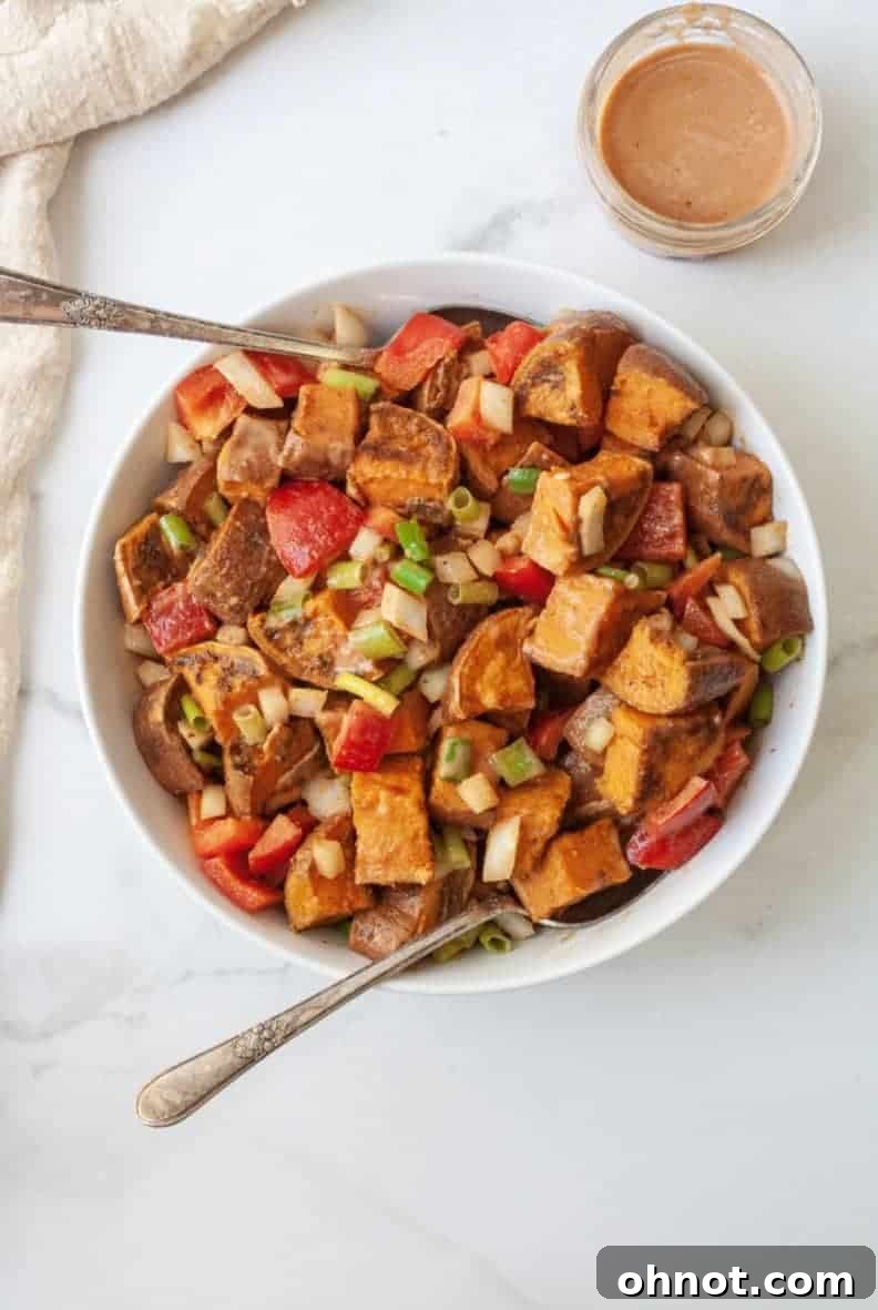 Delicious Southwestern Sweet Potato Salad served in a bowl, garnished with fresh green onions.