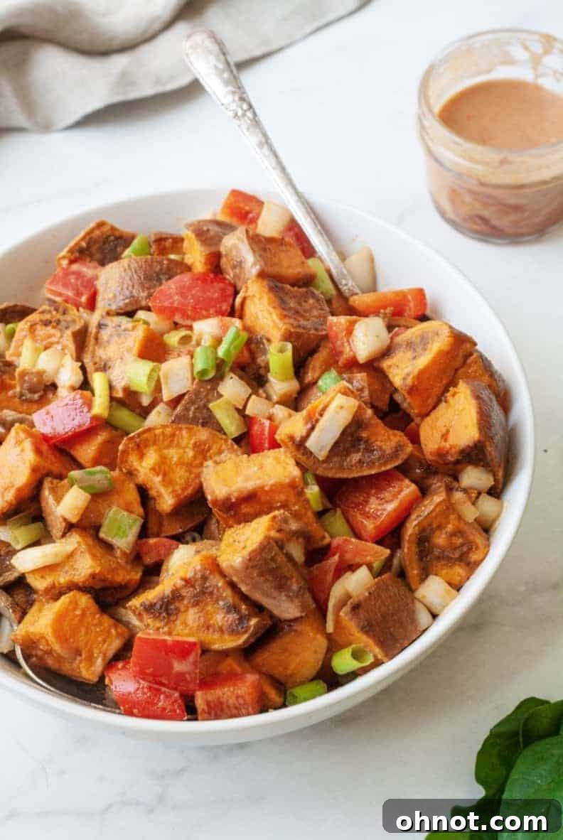 Close-up shot of the vibrant Southwestern Sweet Potato Salad with its creamy dressing.