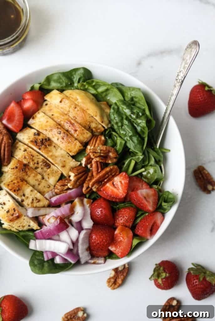 Whole30 salad with grilled chicken and strawberries, featuring fresh greens, bright red strawberries, and golden-brown chicken