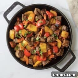 Whole30 Garlic Steak bites in a cast iron skillet.