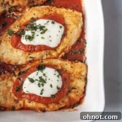A white casserole dish with Whole30 Chicken Parmesan.