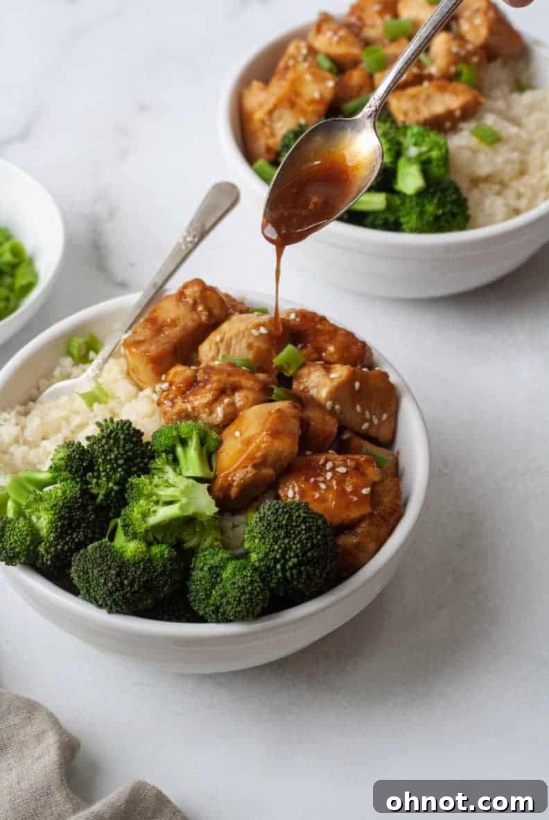 Cooked Whole30 Teriyaki Chicken in a skillet, coated in a thick, glossy sauce.