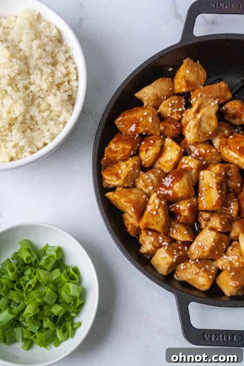 A beautifully plated dish of Whole30 Teriyaki Chicken with cauliflower rice and broccoli, ready to be served.