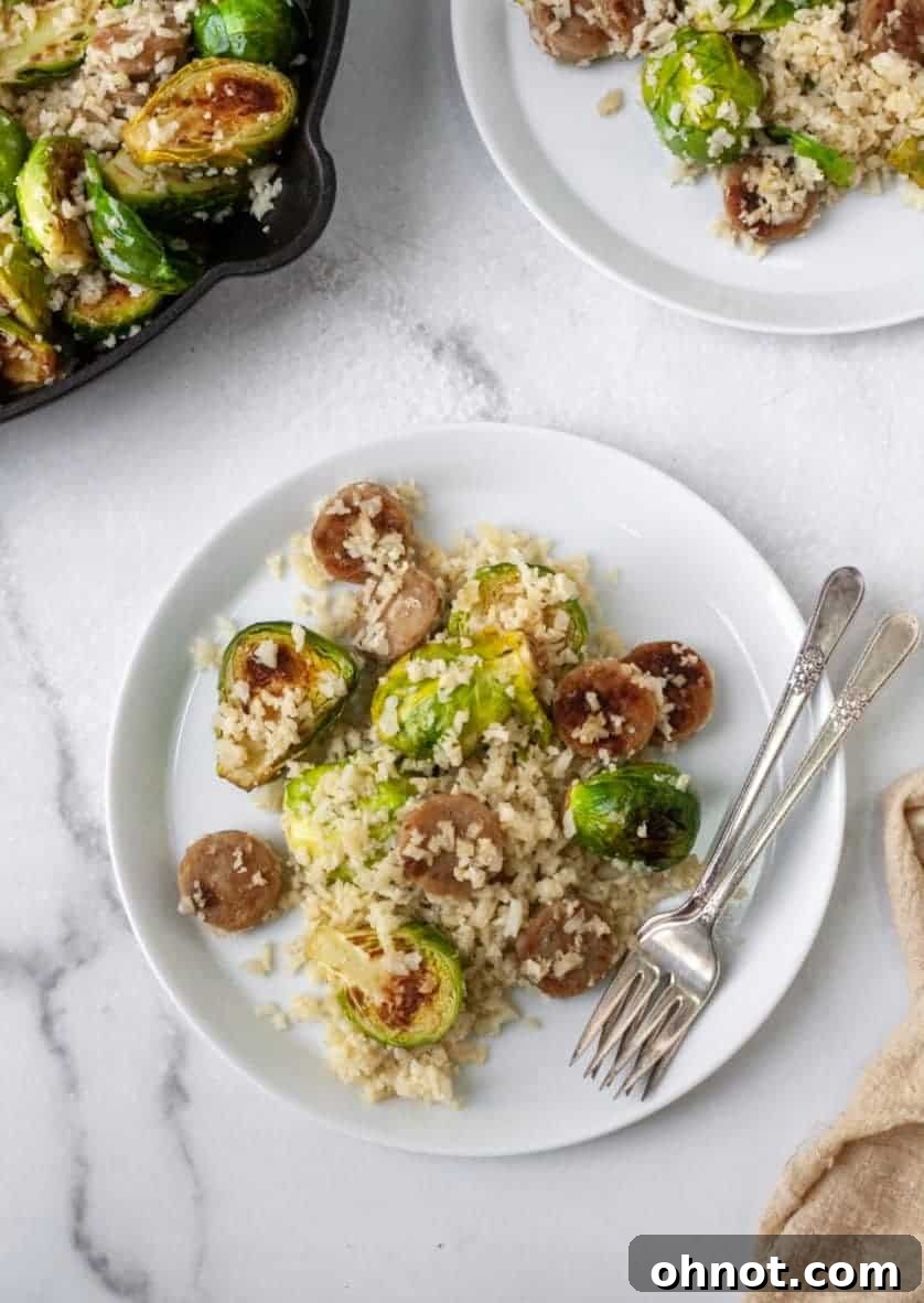 A beautifully plated One-Skillet Sausage and Brussels Sprouts with Cauliflower Rice, ready to be enjoyed.