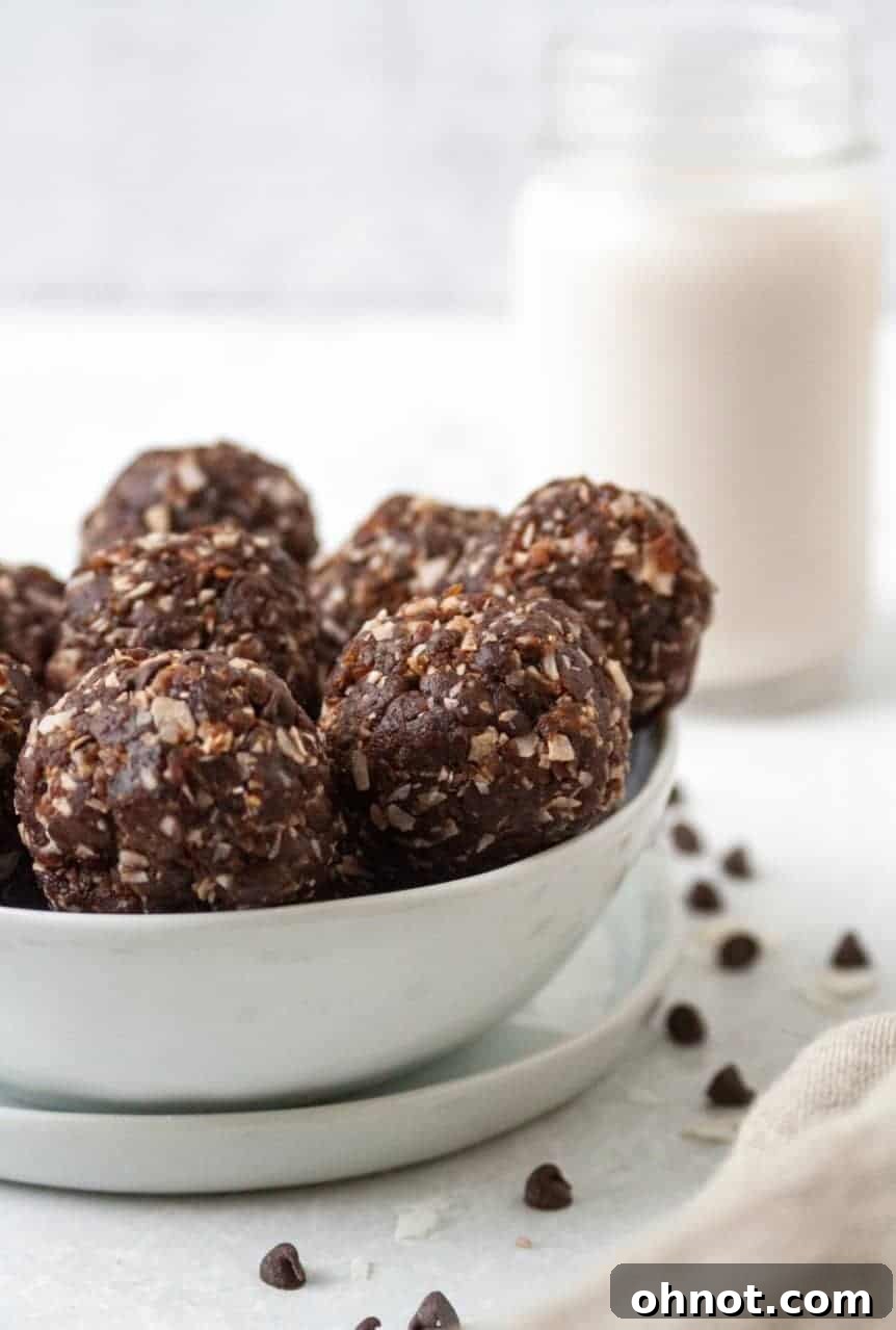 Delicious Paleo Vegan Almond Joy Bites on a plate, showcasing their chocolate and coconut coating.