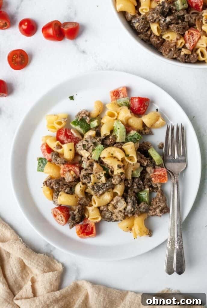 An individual serving of vibrant Gluten-Free Taco Pasta Salad on a clean white plate, garnished for presentation