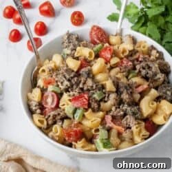White bowl with a vibrant serving of Gluten-Free Taco Pasta Salad