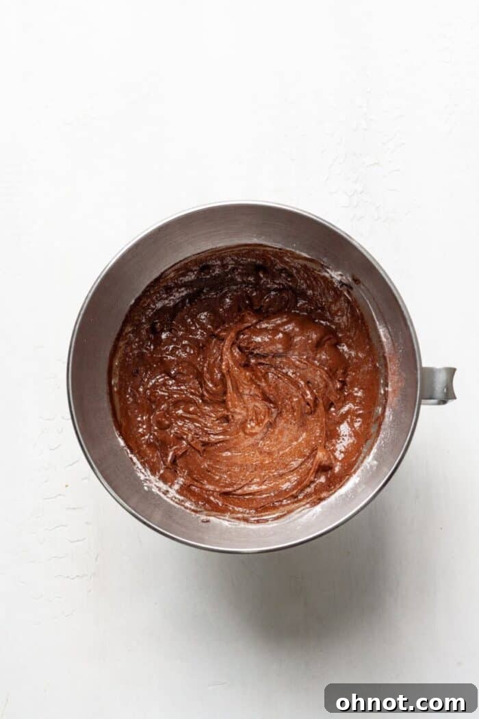 Thick brownie batter in a bowl, ready for baking