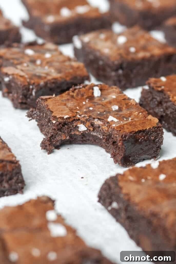 Paleo fudge brownies arranged beautifully on a white backdrop, ready for serving