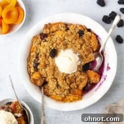 Gluten free apricot blackberry cobbler in white pie dish