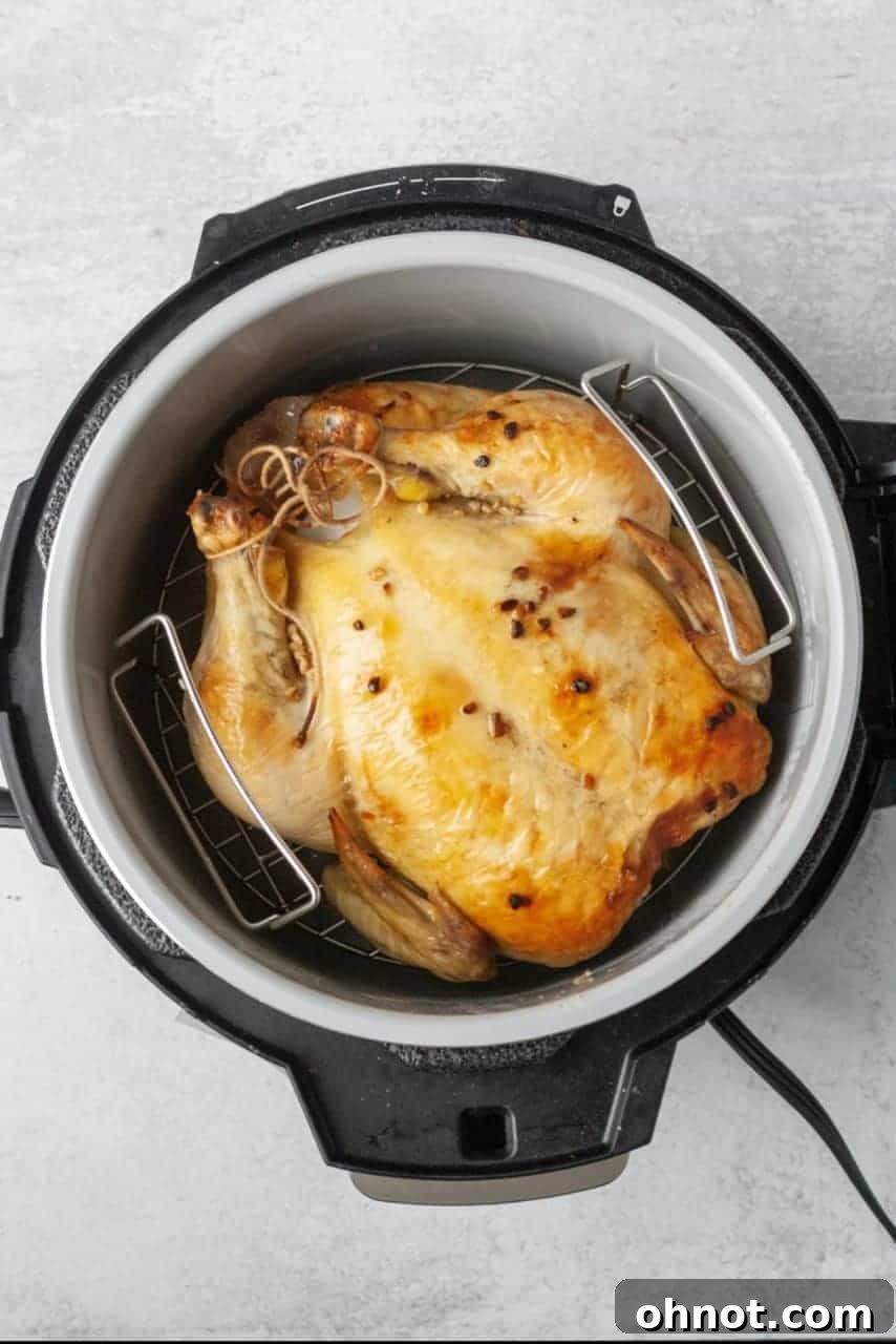 Perfectly cooked and sliced Instant Pot whole chicken on a wooden cutting board
