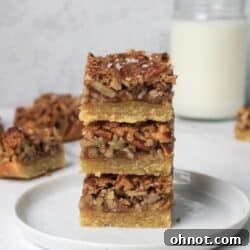 Paleo Pecan Pie Bars on a white plate, close up.