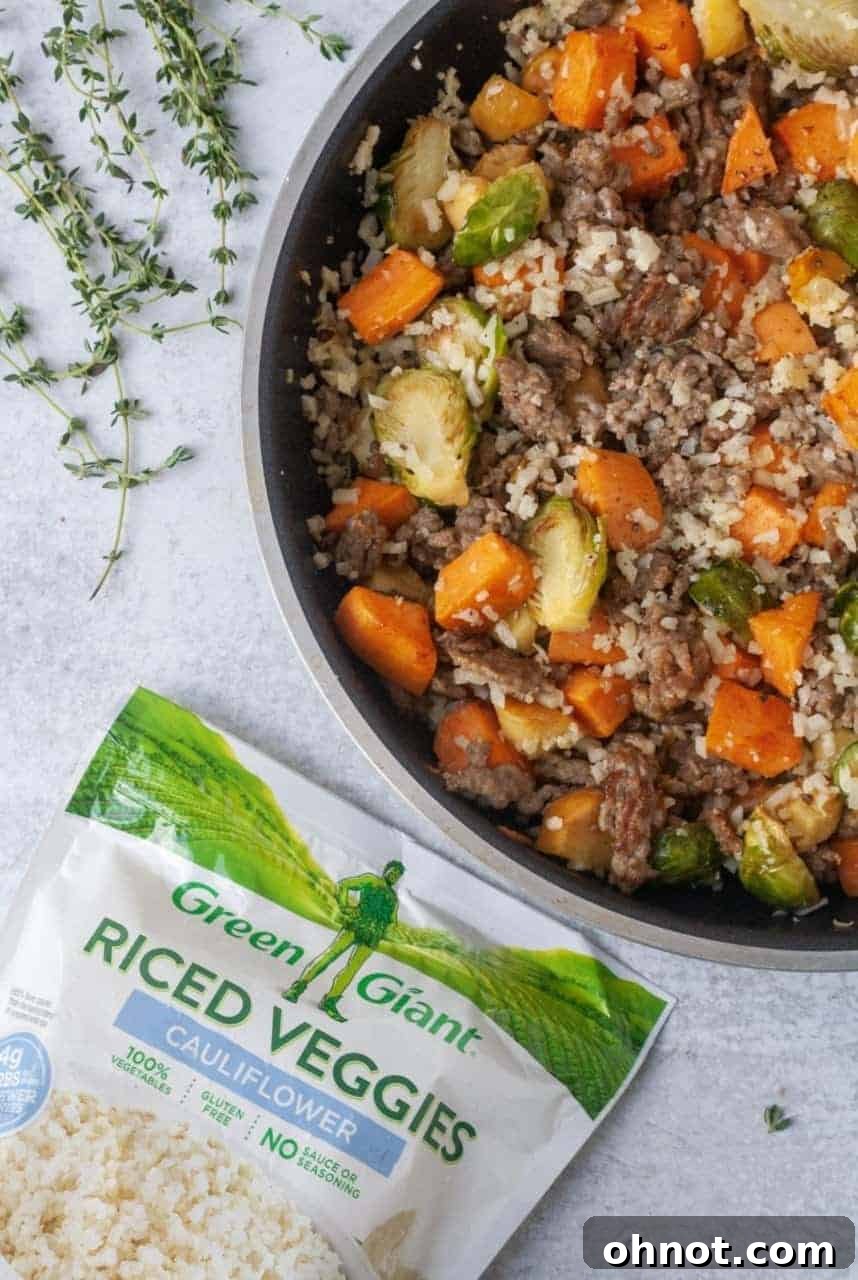 Close-up of Whole30 Sausage and Veggie Stuffing in a skillet, showing texture and ingredients.