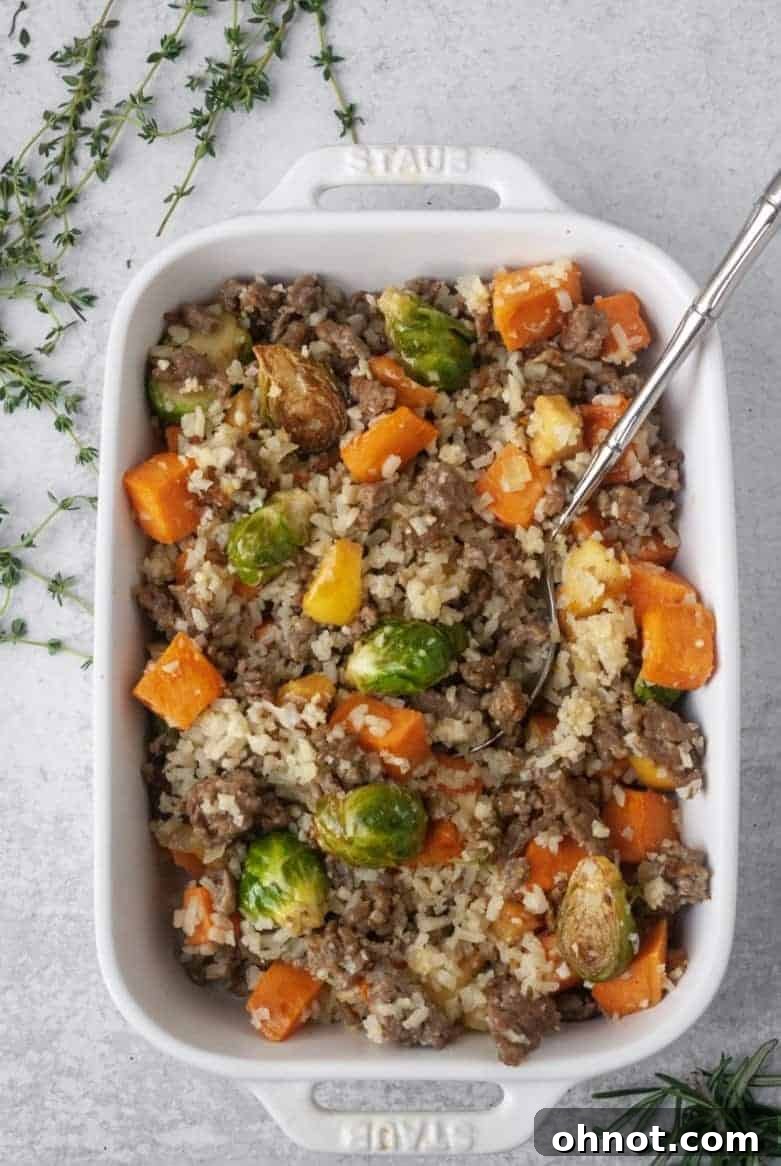 Plated Whole30 Sausage and Veggie Stuffing with a fork, ready to eat.