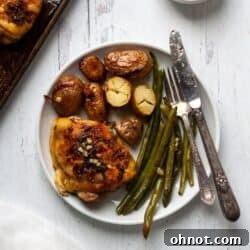 Chicken thighs on sheet pan with potatoes and veggies