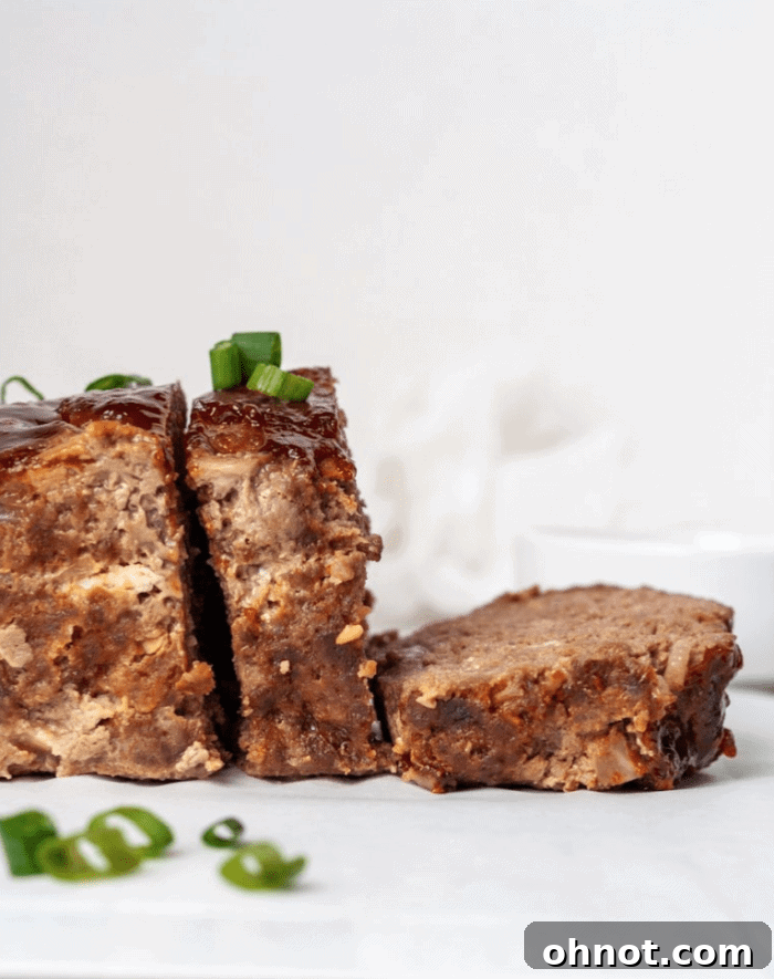 The uncooked Whole30 Paleo Asian Meatloaf mixture in a bowl, showing texture.