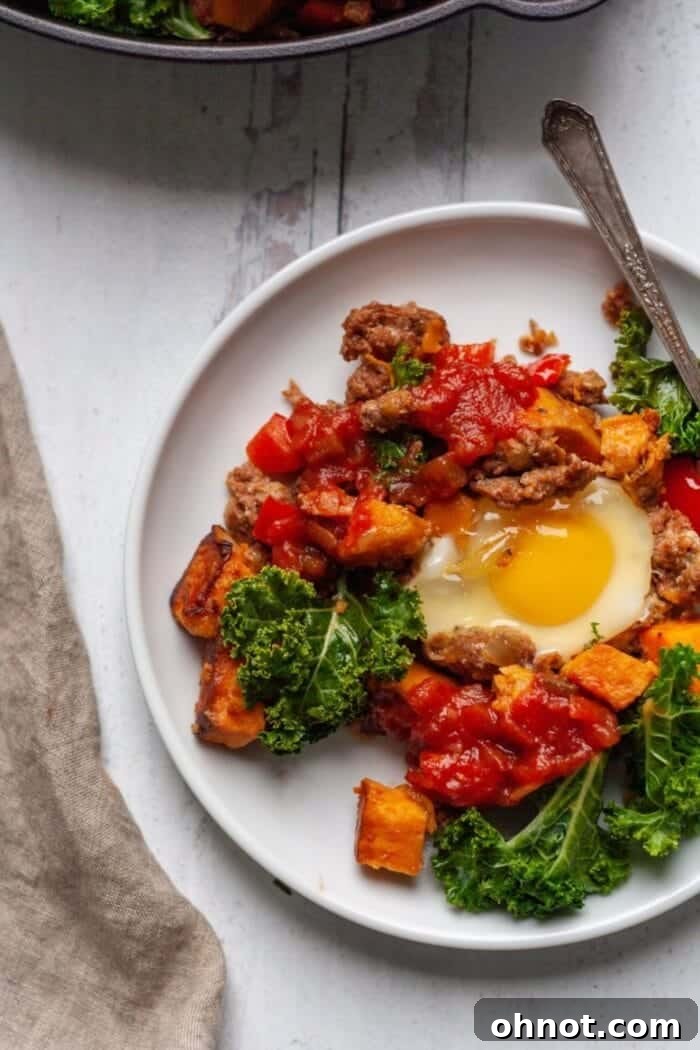 A skillet of Whole30 breakfast hash garnished with fresh cilantro and lime wedges.