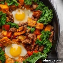 A cast iron skillet filled with veggies and eggs.