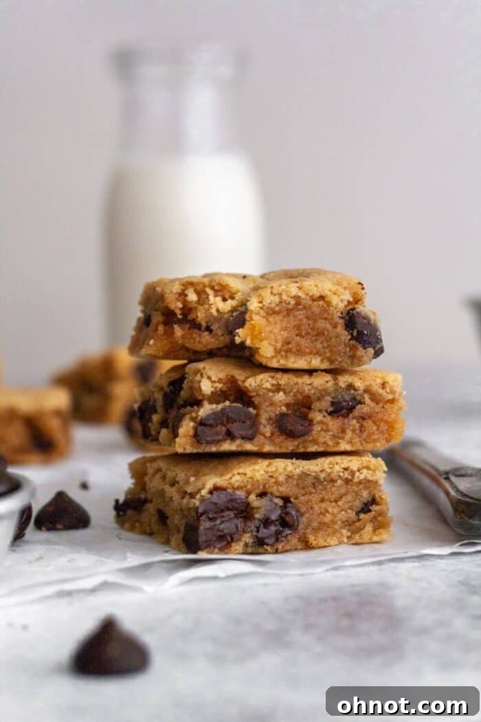 A stack of gluten free blondies with a glass of milk.