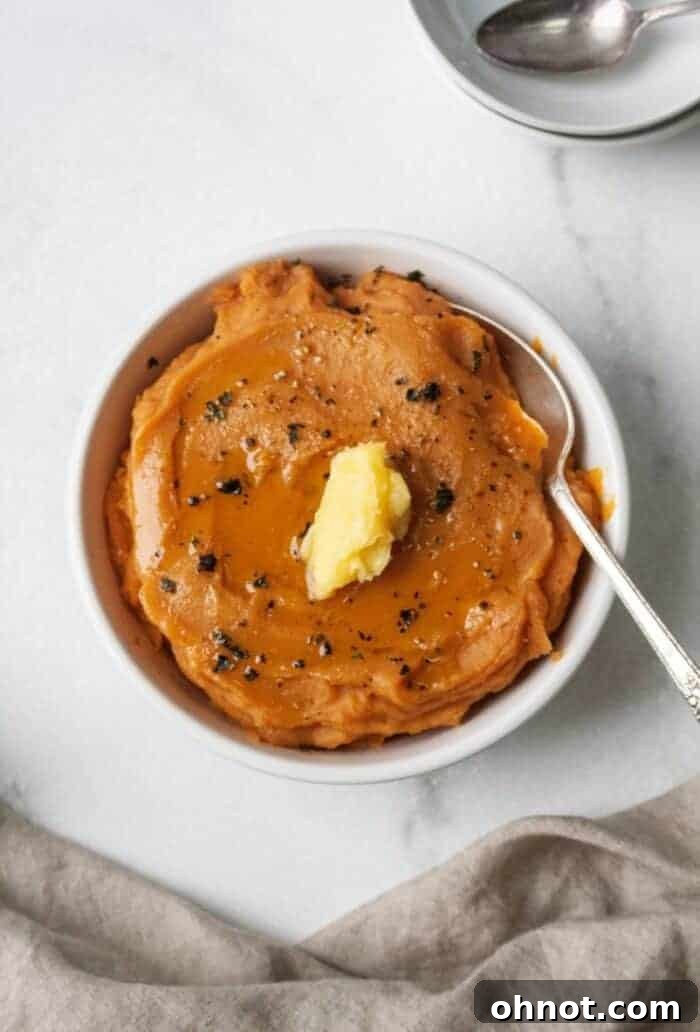 A bowl of mashed sweet potatoes topped with ghee.