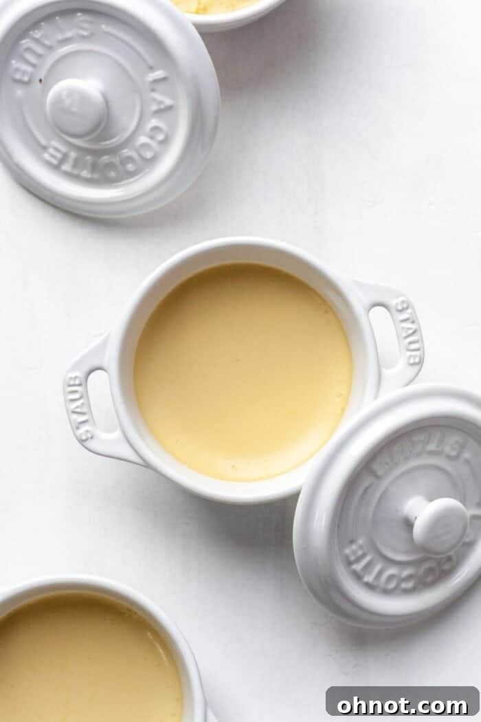 A white ramekin filled with yellow custard.