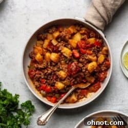 Paleo Taco Skillet in a white skillet with a silver spoon.