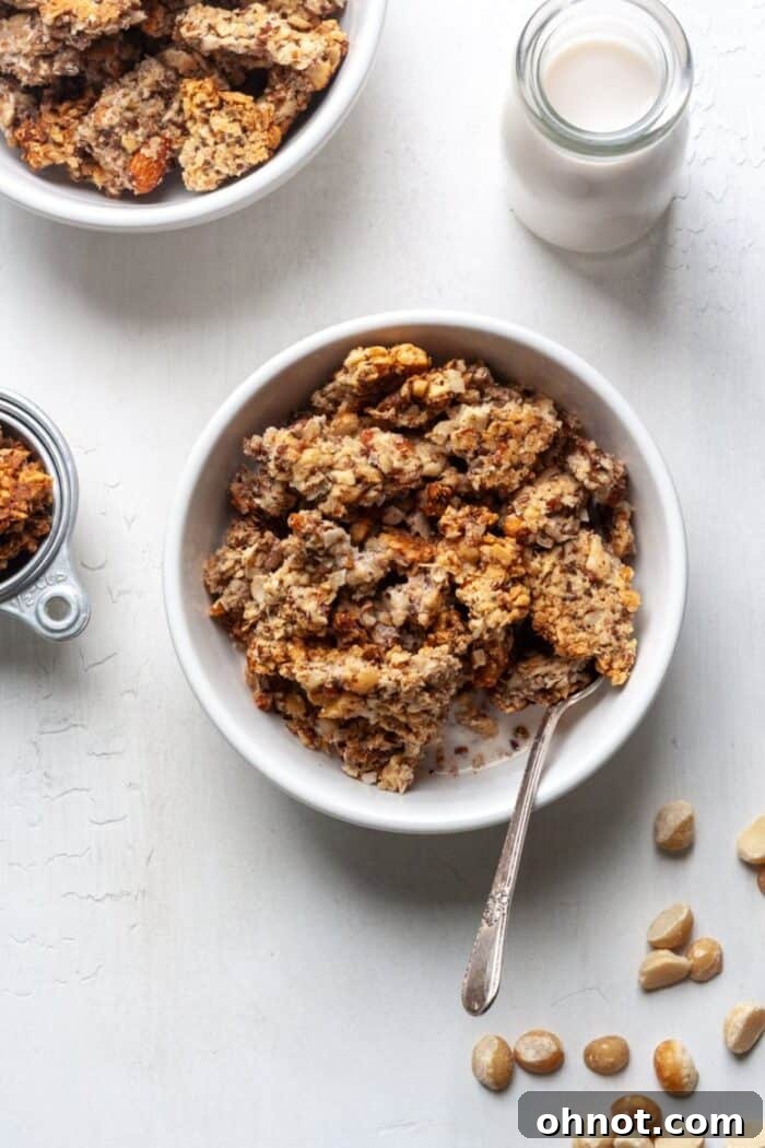 Grain free granola in a white bowl with milk.