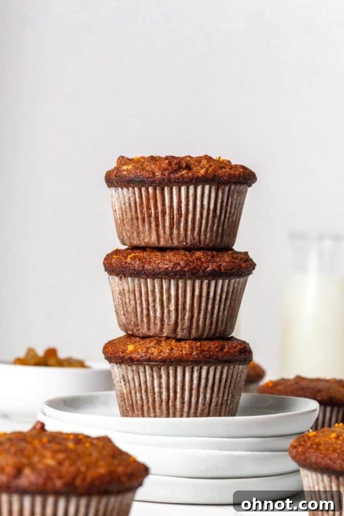 Paleo Morning Glory Muffins on white plates, showcasing their delicious texture and inviting appearance.