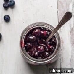 A glass jar filled with luscious Vegan Blueberry Jam.
