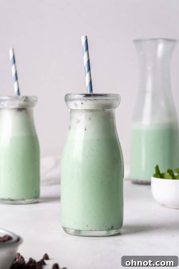 A glass jar filled with Dairy Free Mint chocolate smoothie.